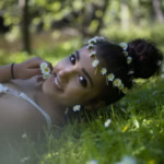 portrait-girl-wearing-flowers-while-lying-grass_1048944-24931876